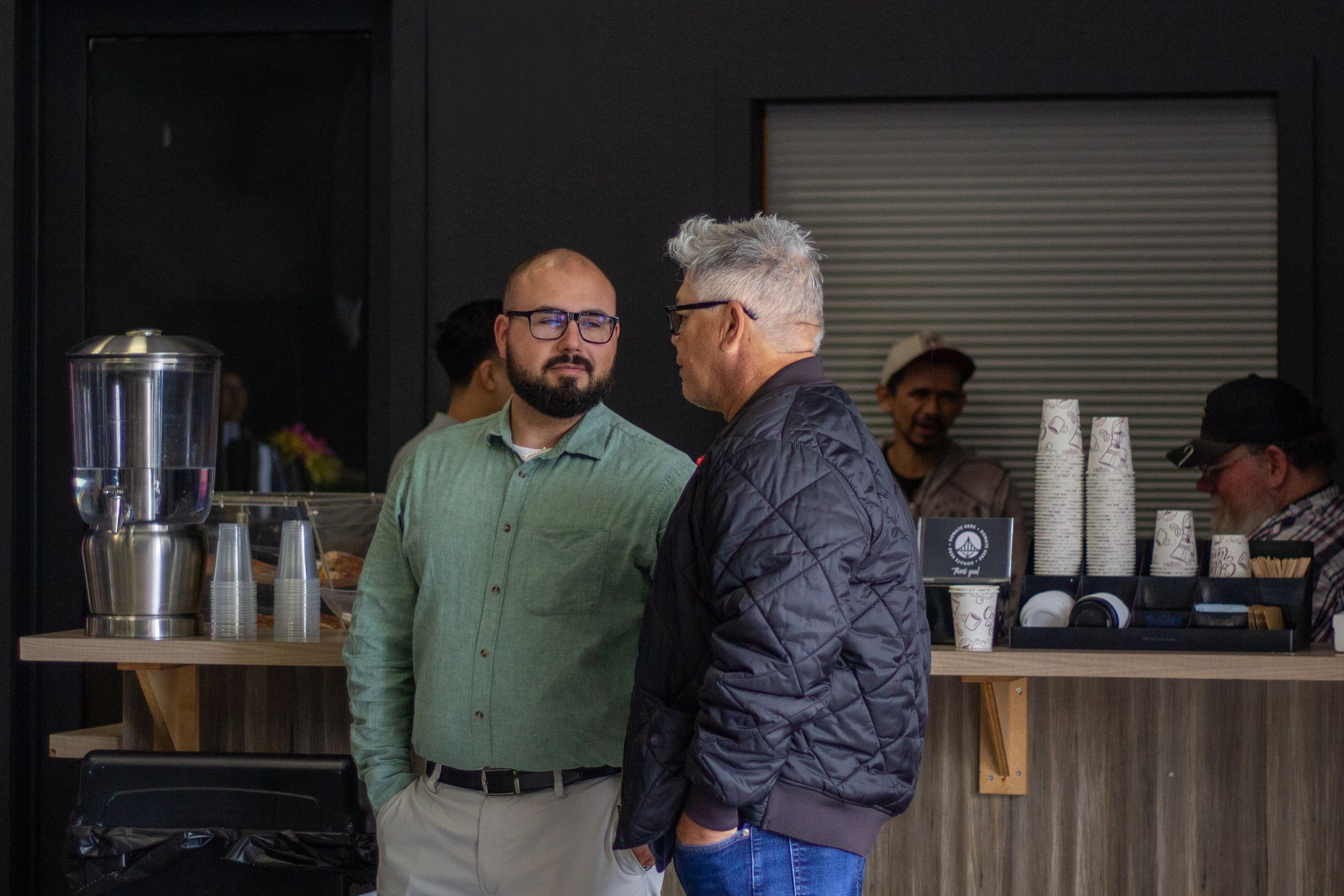 Two men talking at the LifeBridge coffee bar on a Sunday morning