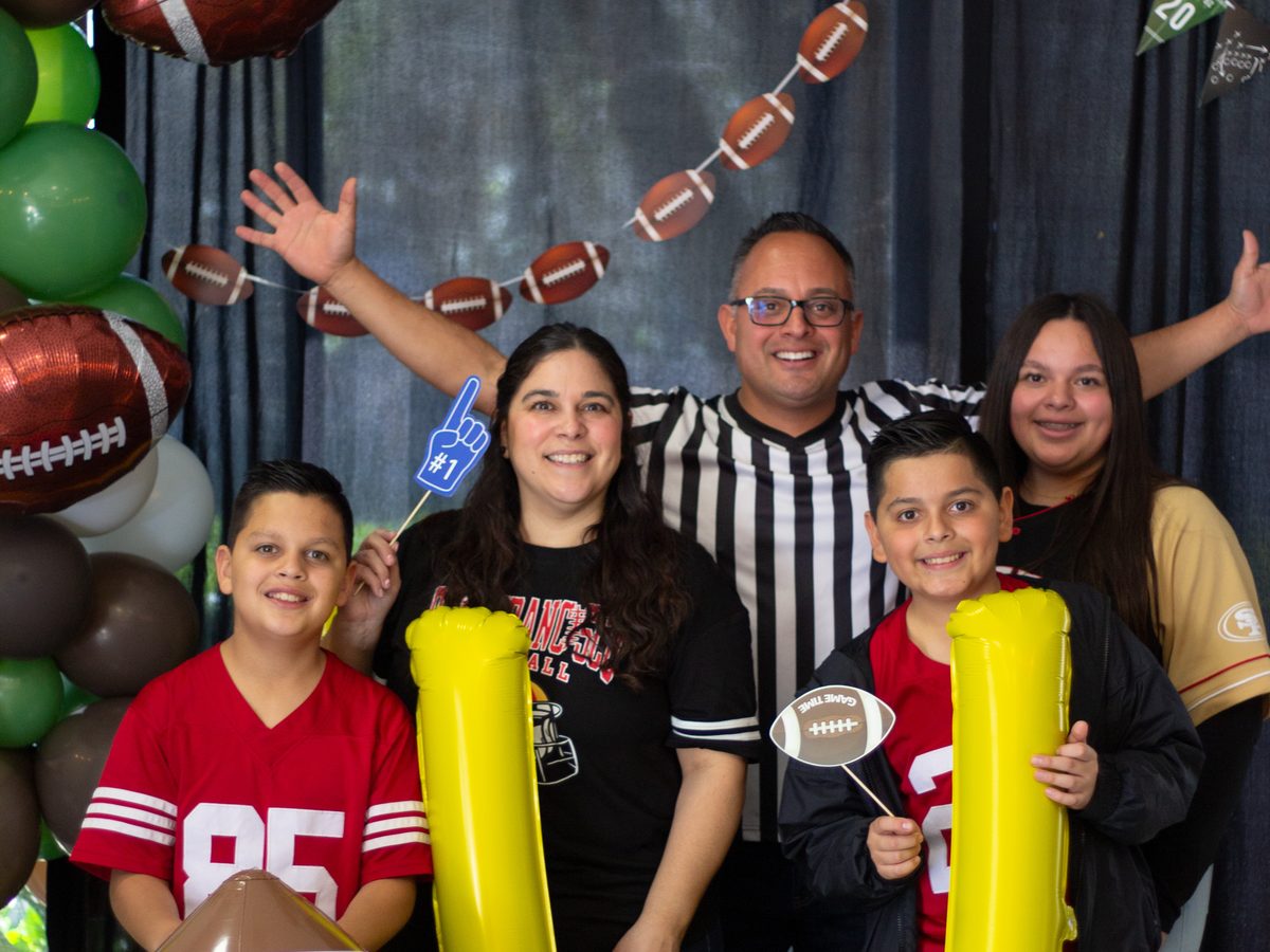 A family at the Draft Sunday photo booth