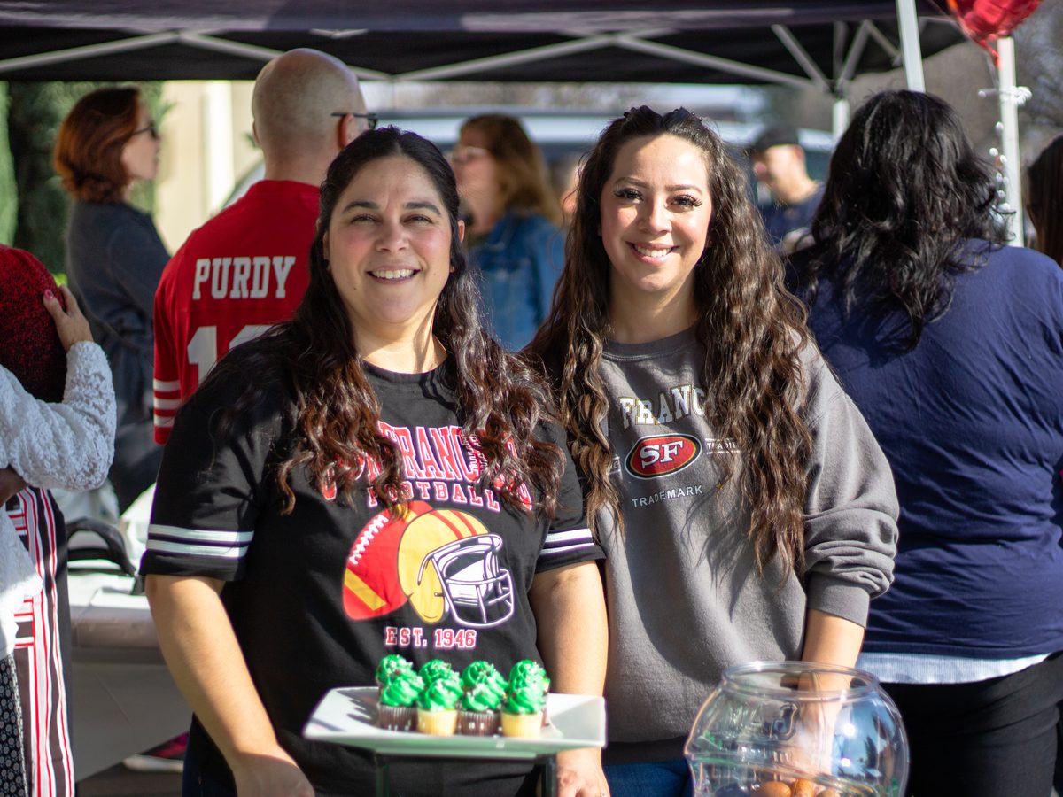 Two volunteers serving at the outreach tent