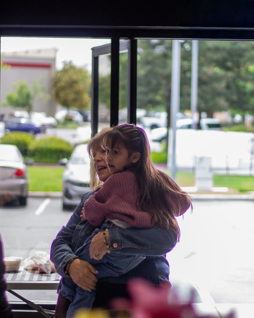 A father holding his daughter at the church entrance