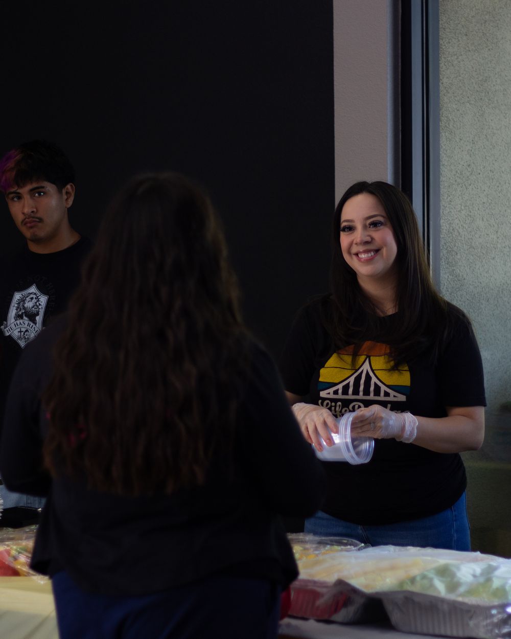 Volunteers serving at the outreach food table